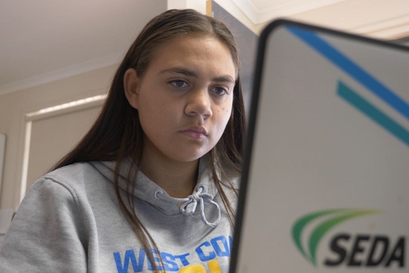 Shania Cross looking at her computer.