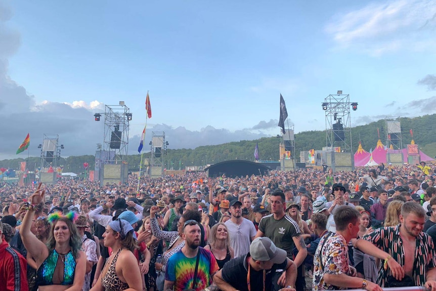 A large crowd inside a music festival.