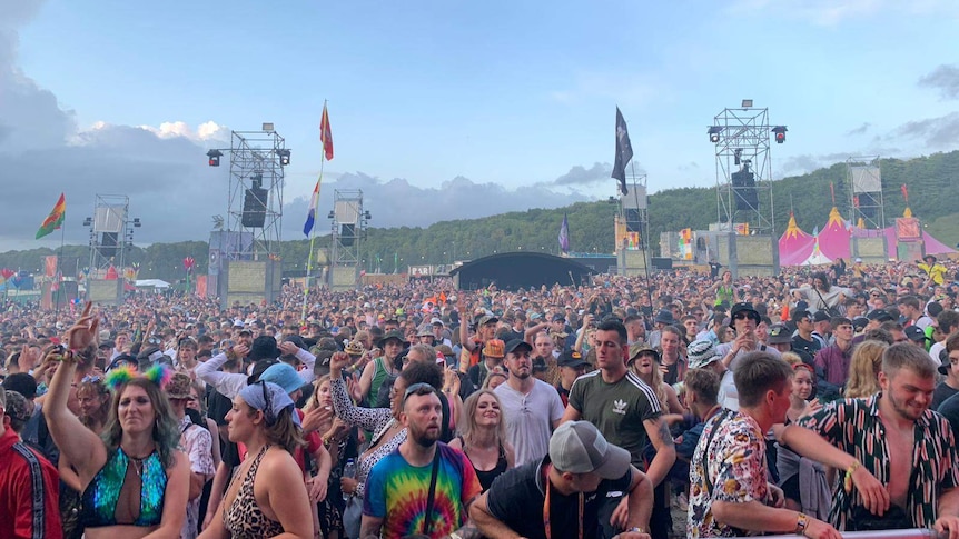 A large crowd inside a music festival.