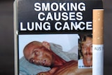 Cigarette packet showing a picture of a lung cancer victim and a health warning