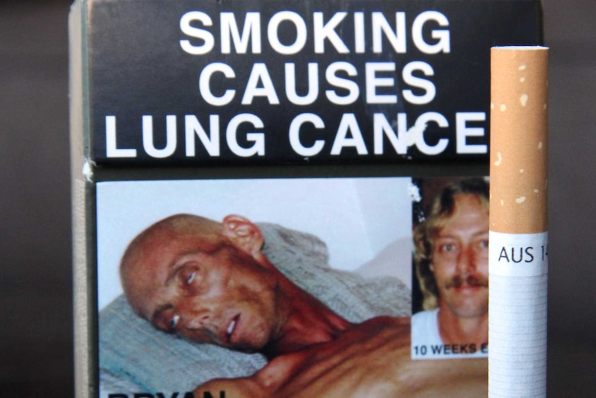 Cigarette packet showing a picture of a lung cancer victim and a health warning