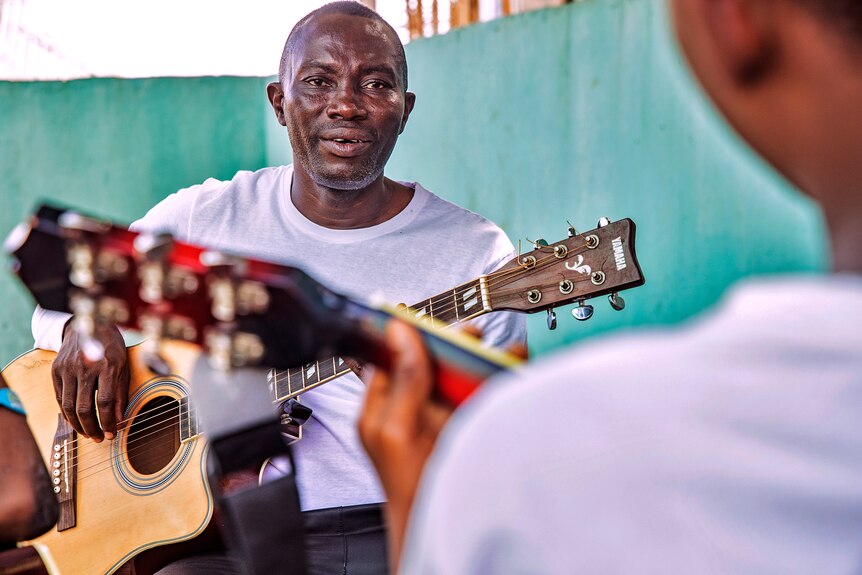 Victor Erebifa Phullu teaching guitar at his local church. 
