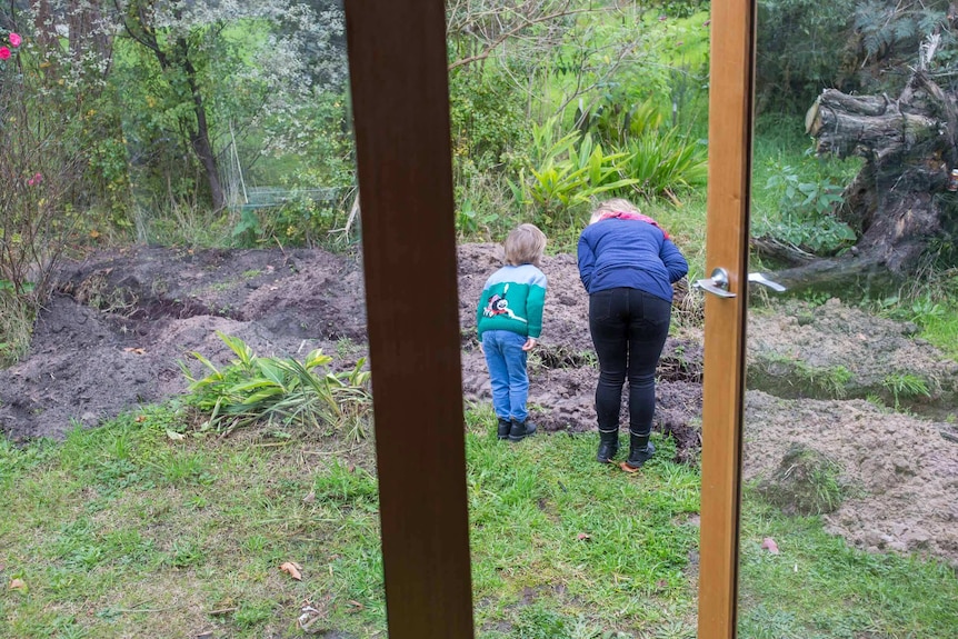 Sarah Smethurst and her nephew look in the garden.