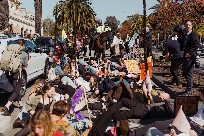 Climate protesters lying on the road at Parliament House in Perth.