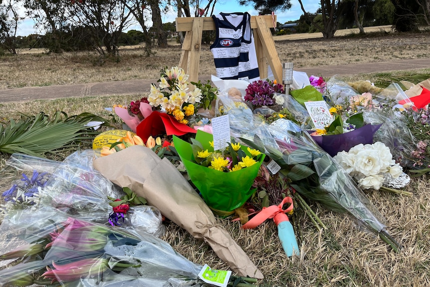 Flowers, a guernsey and notes left at the scene of the crash at Goolwa.
