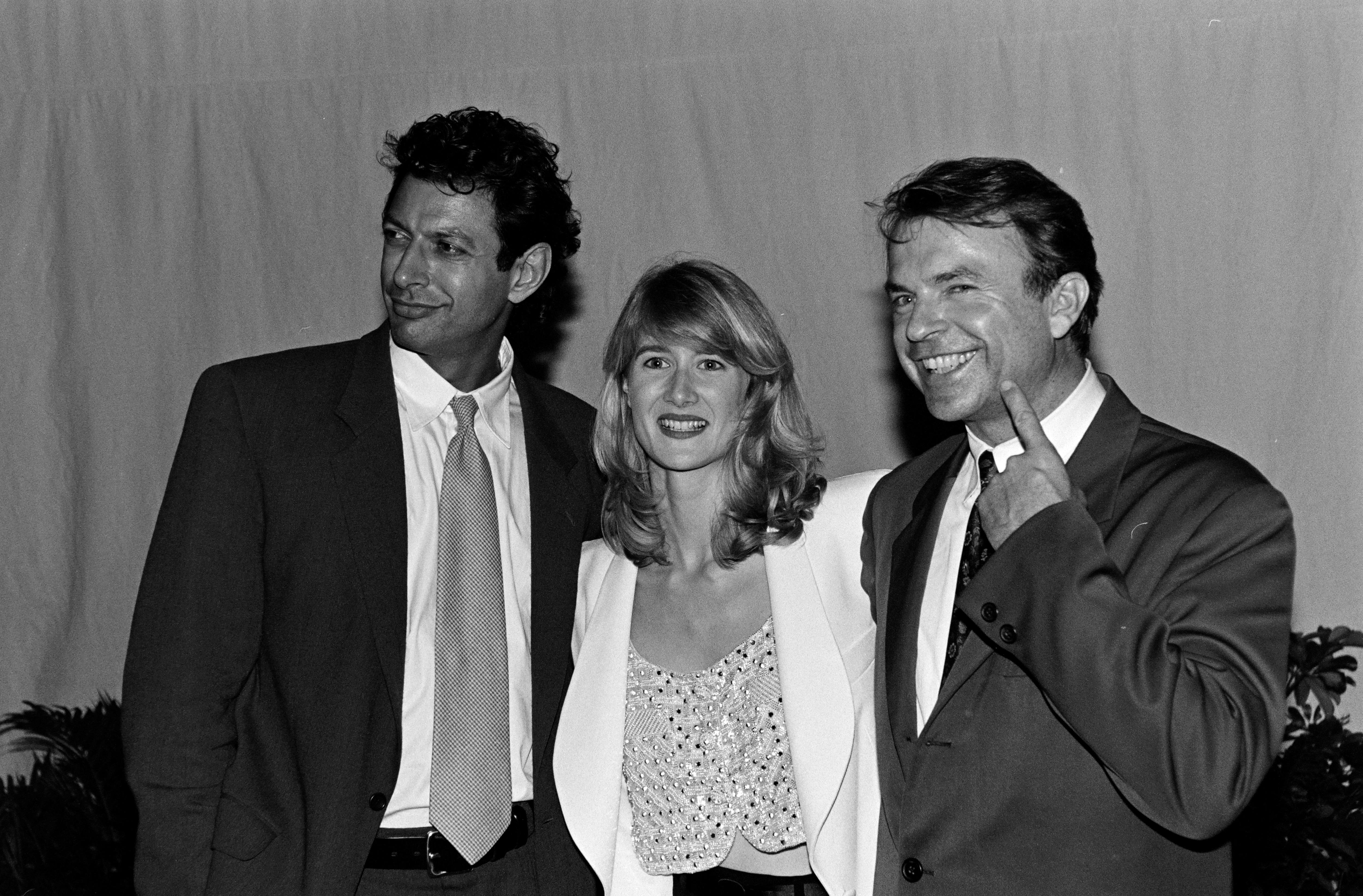 Black and white image smiling Jeff Goldblum, Laura Dern and Sam Neill
