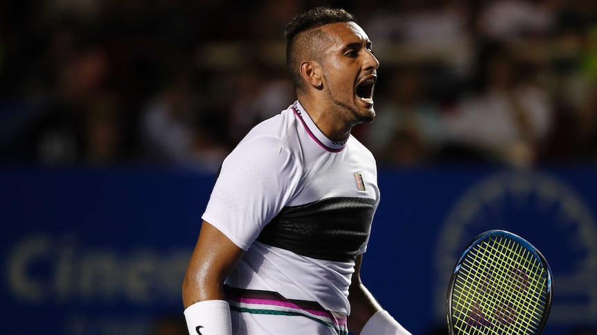 Nick Kyrgios screams in delight while holding his racquet.