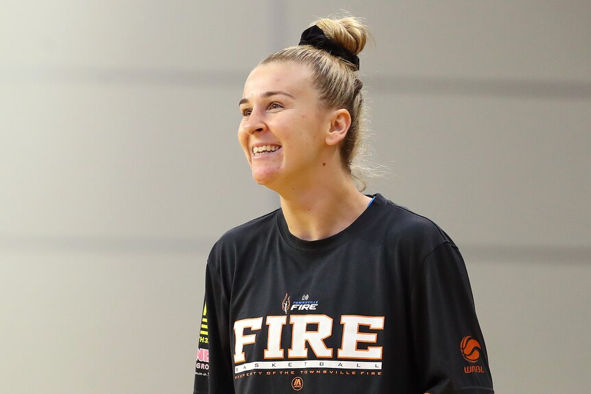 Stephanie Reid smiles while on the basketball court.