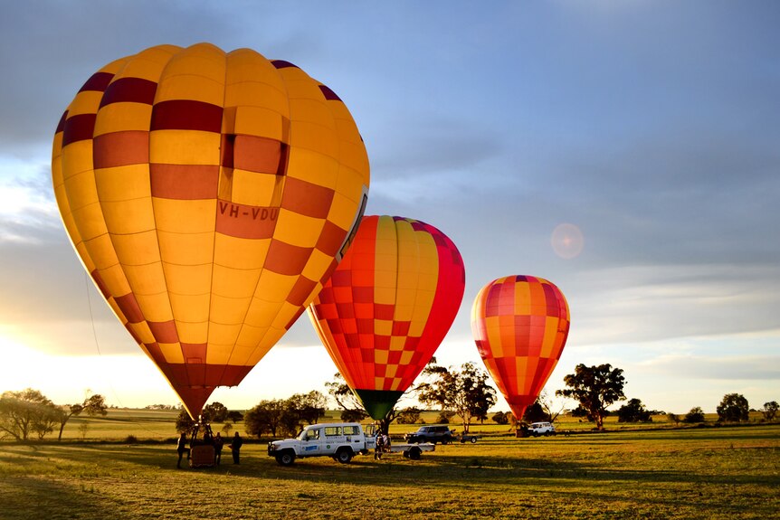Balloons ready to fly as the sun rises over Northam.