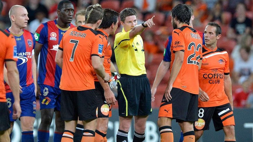 Referee Brenton Hayward sends off Thomas Broich in Brisbane's match with Newcastle at Lang Park.