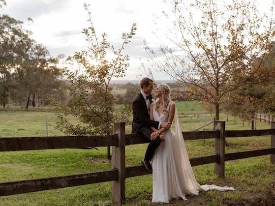 The couple kissing on their wedding day. 