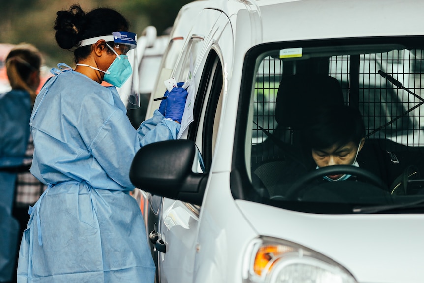 A man undergoes a COVID-19 test at a testing centre in Fairfield, in Sydney's south-west. 