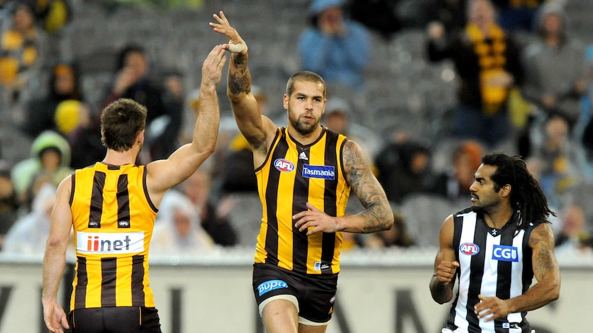 Lance Franklin of Hawthorn celebrates with team-mate Brendan Whitecross against Collingwood.