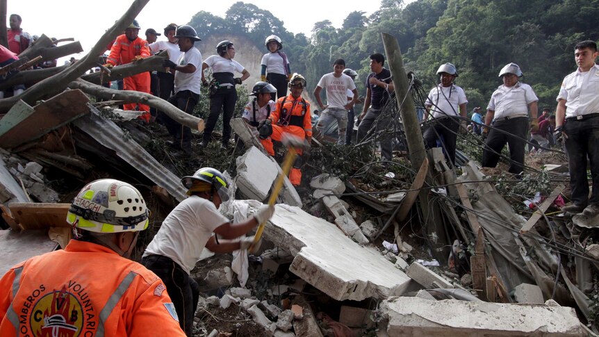 Rescue team members search for landslide victims