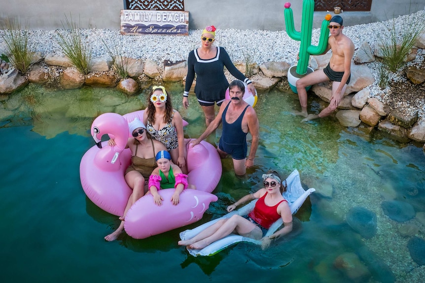 Mandy Nolan and family posing in their natural pool.