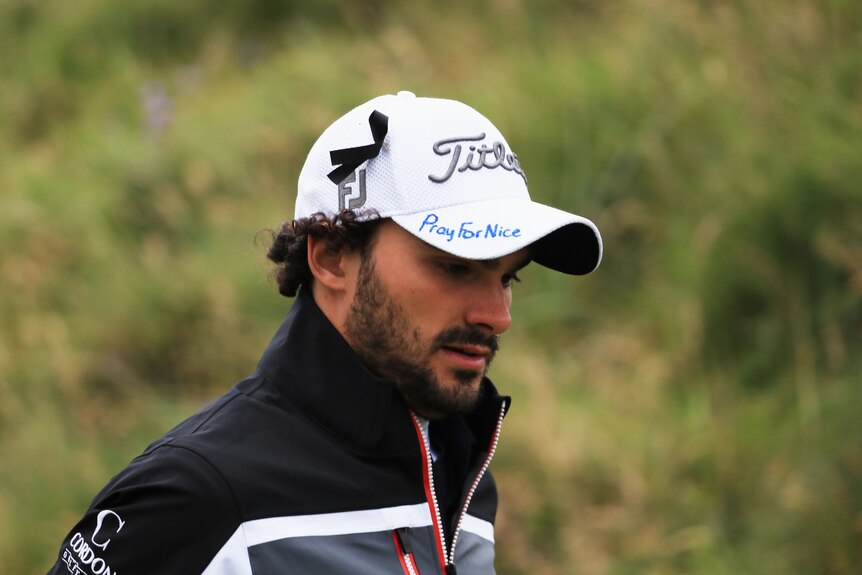 Clement Sordet of France displays tributes to the victims of the recent Nice attack on his cap