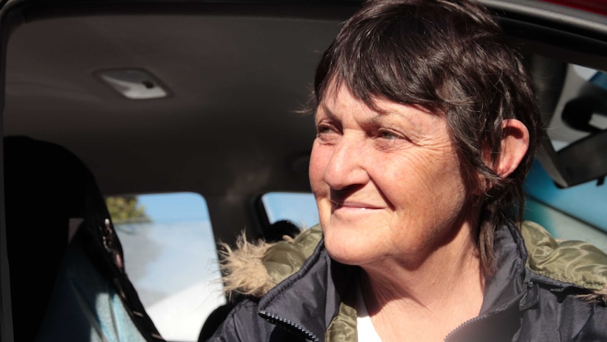 A woman sitting in her car