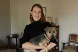 Teenager Amelia Morris holds her dog