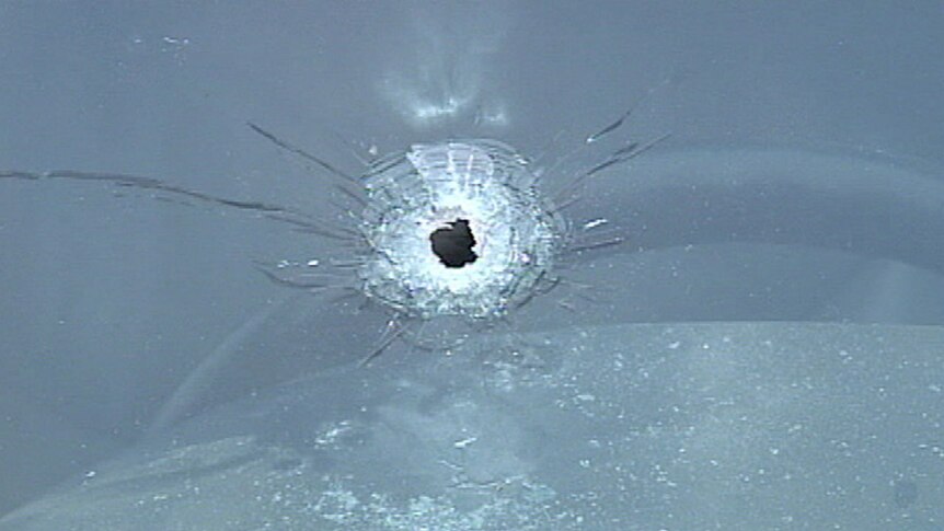 A bullet was fired through the windscreen of a car outside Desmond Moran's home.
