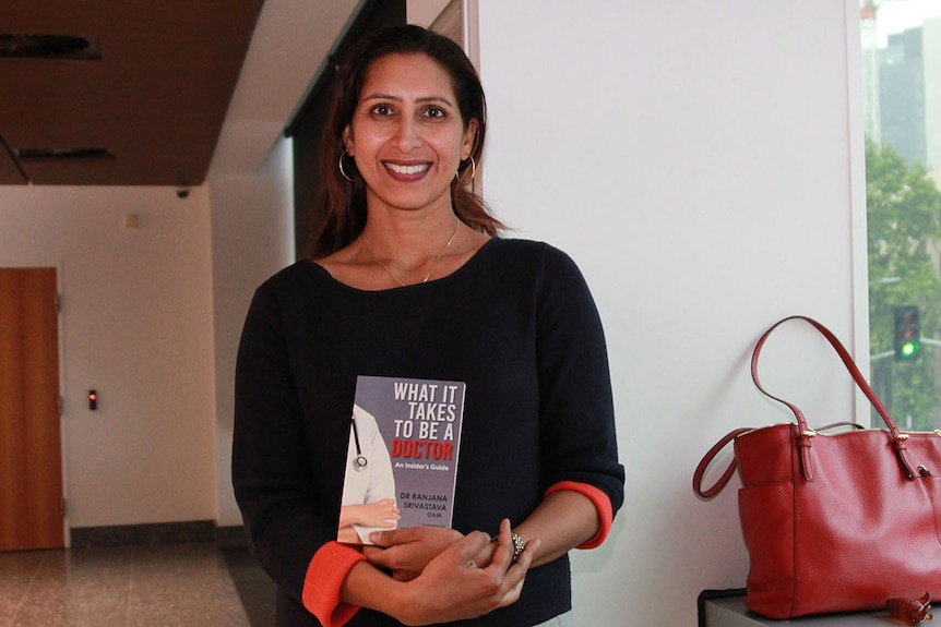 Professor Ranjana Srivastava holds the book she wrote.
