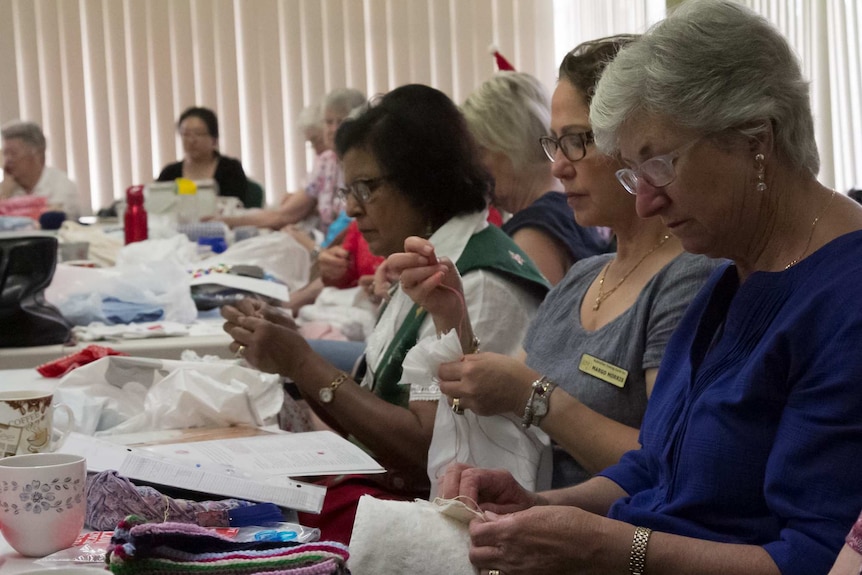 Women hand sewing