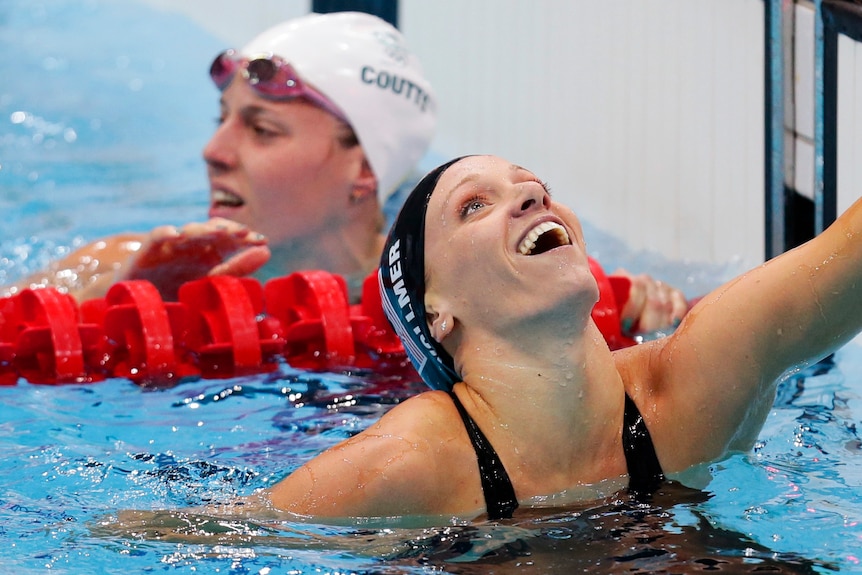 Dana Vollmer celebrates winning the women's 100m butterfly final.