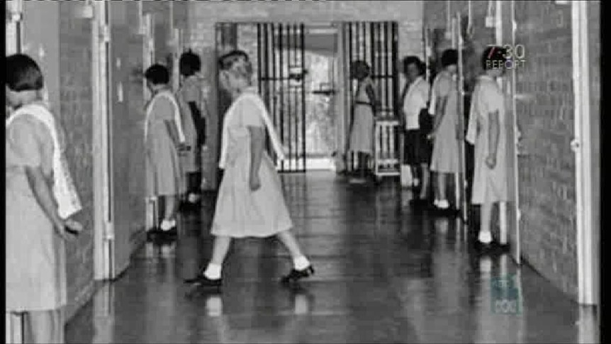 A black and white photo of girls in a boarding home.