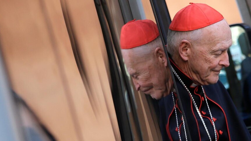 Cardinal Theodore Edgar McCarrick steps out through a door