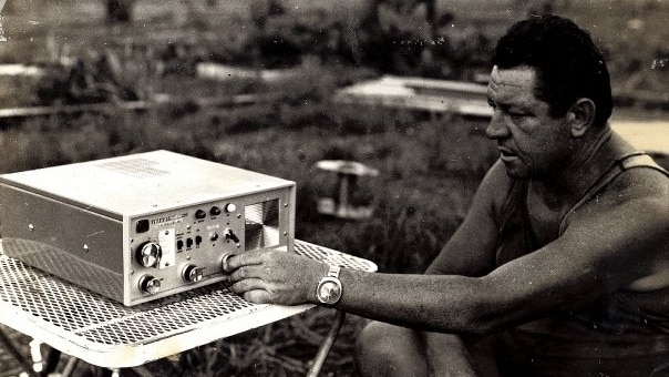 Brian Manning adjusting radio transmission equipment.