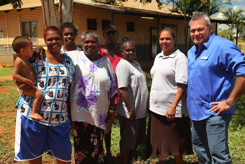 Mr Greatorex stands with a group of community residents and Pandanus Park acting chief executive Patricia Riley.