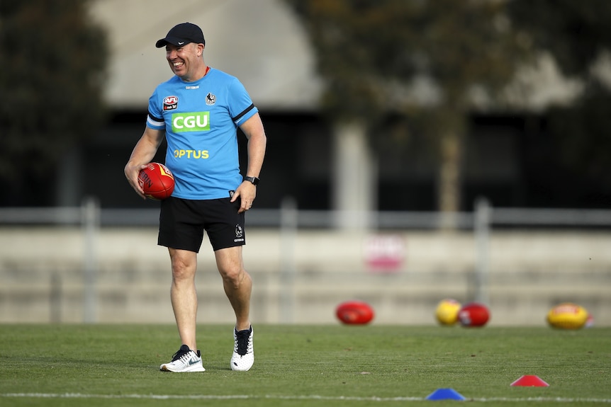 Scott Gowans, Senior Assistant/Midfield Coach of the Magpies smiles while holding a ball during a Collingwood training session