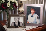 Two photographs of a smiling woman on a side table.