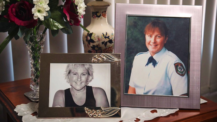 Two photographs of a smiling woman on a side table.