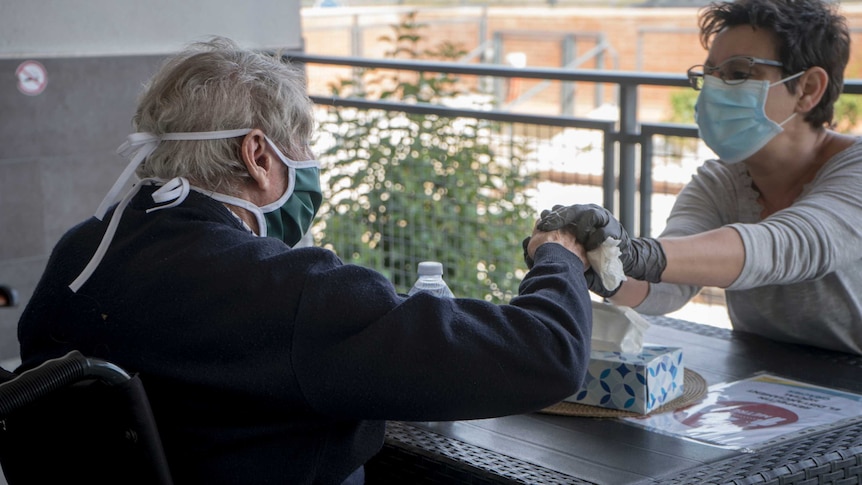 photo of older person in aged care with visitor