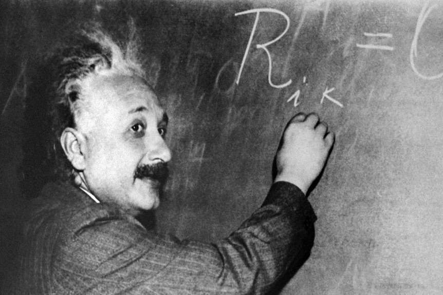 An undated photo of physicist Albert Einstein with blackboard
