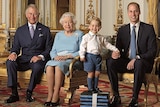 Prince Charles, Queen Elizabeth II, and Prince William seated, with Prince George standing on a small raised platform.
