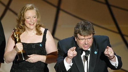 Michael Moore responds to the audience after winning an Oscar for Best Documentary Feature