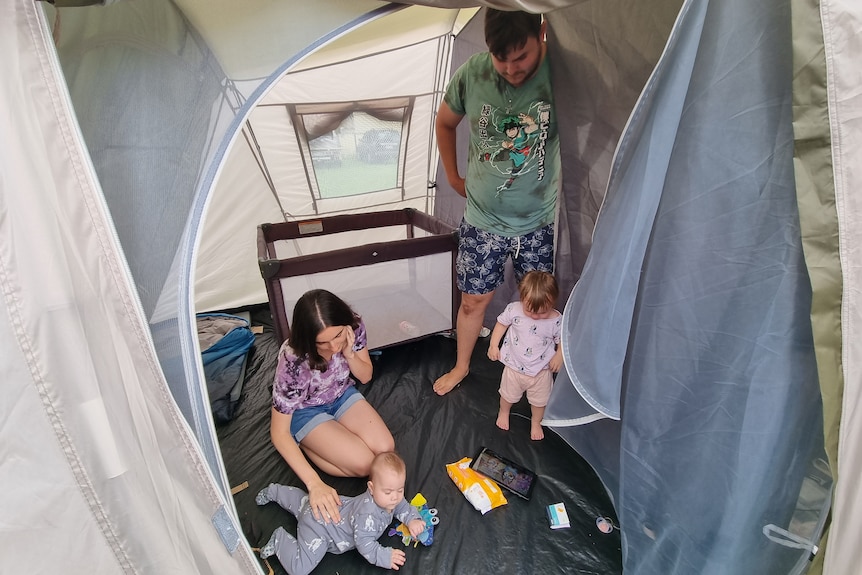 Suz in the tent with her husband and two young children.