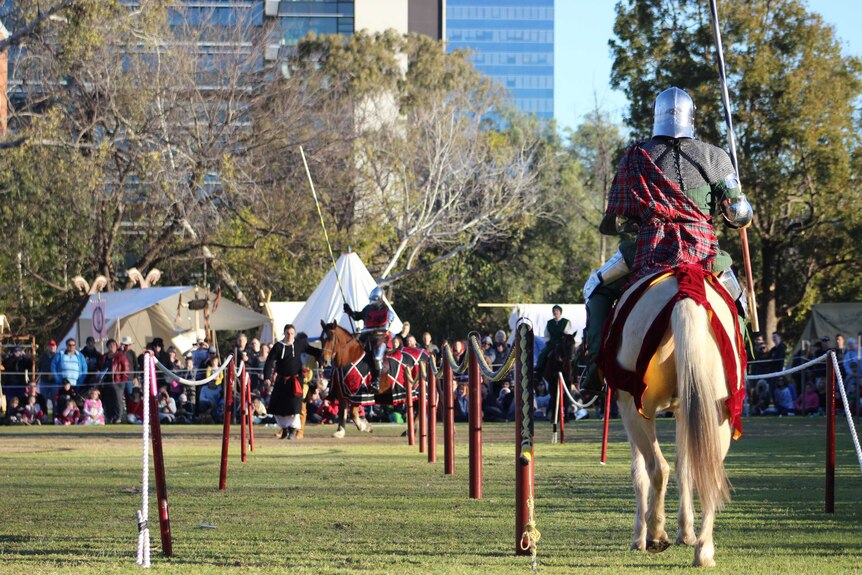 Competitors line up to joust