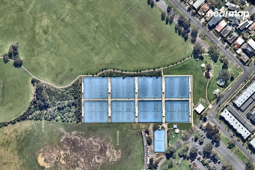 A picture from above shows sporting fields and tennis courts, surrounded by houses