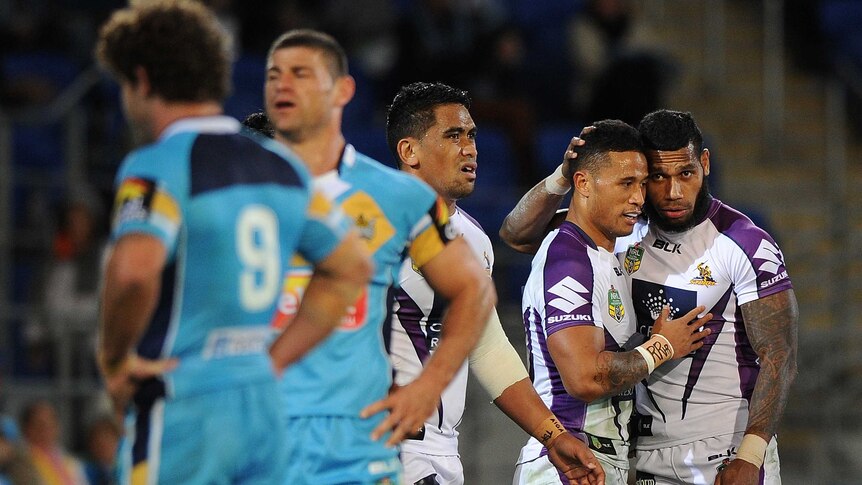 Melbourne Storm celebrate a try against the Titans