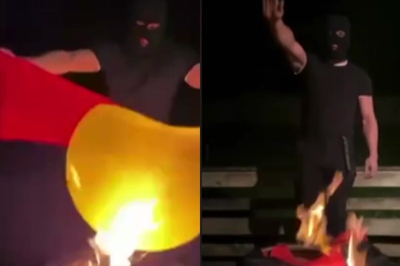 Neo-Nazi burns Aboriginal flag and does Nazi salute.