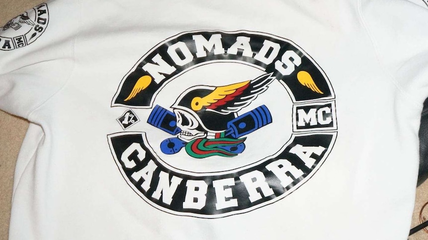 The back of a jumper with the logo Nomads Canberra on it