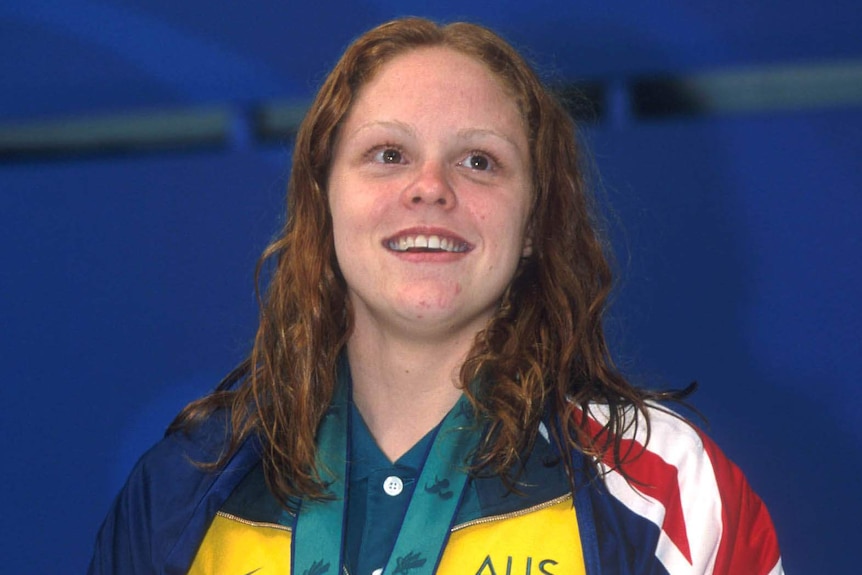 Paralympic swimmer Siobhan Paton stands with her gold medal at the Sydney 2000 games.