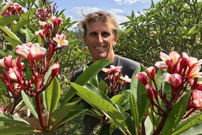 Brenden Clark in behind a flowering tree.