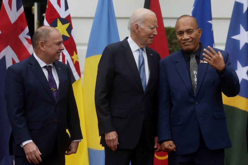 Joe Biden chats with Taneti Maamau as Mark Brown stands next to them. 