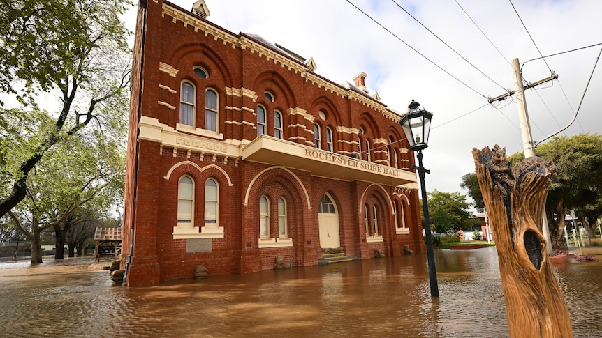A large building sits partially underwater. 