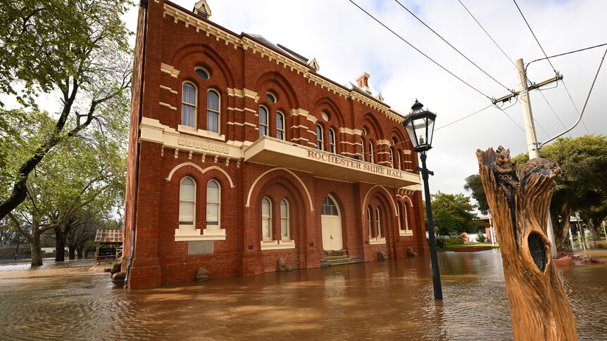 A large building sits partially underwater. 