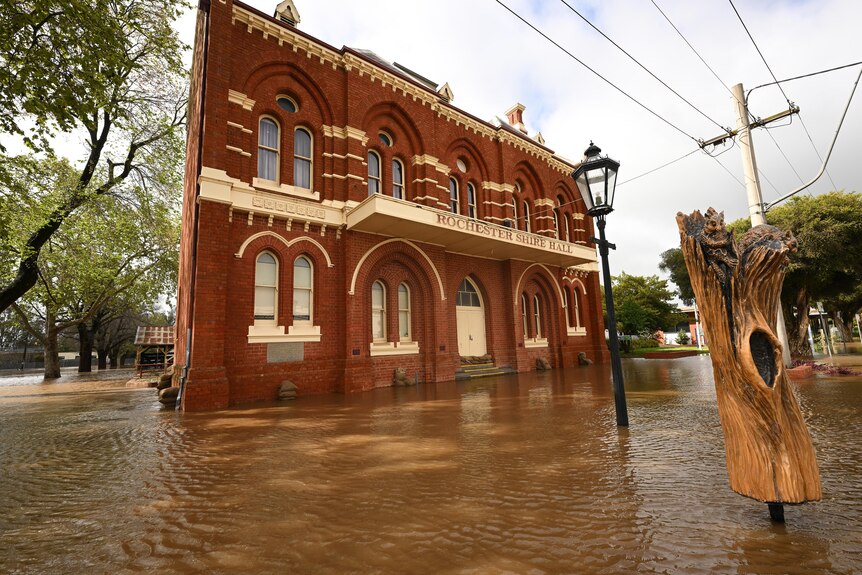 A large building sits partially underwater. 