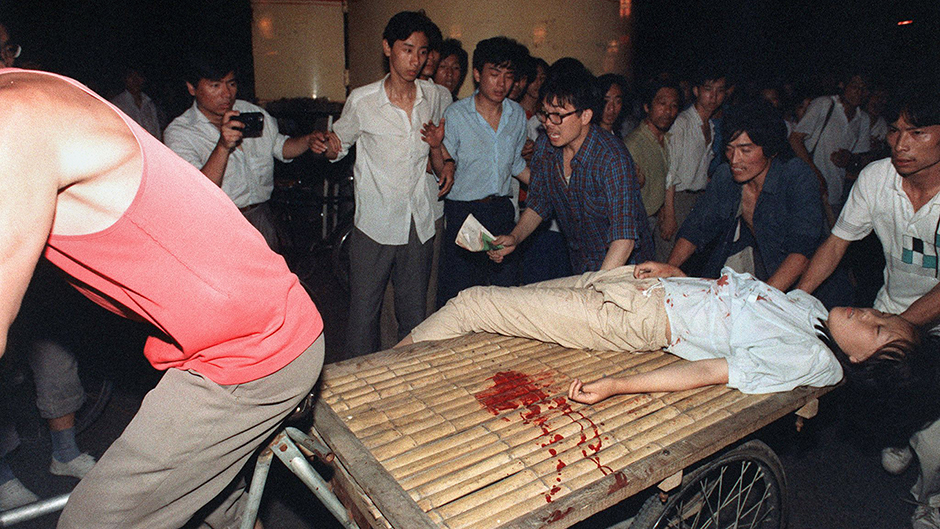 A girl is wounded as the PLA takes Tiananmen Square